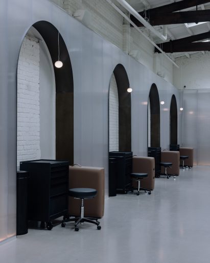 Row of arched niches with tables and cabinets tucked inside