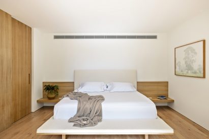 Minimal bedroom with wood and white surfaces