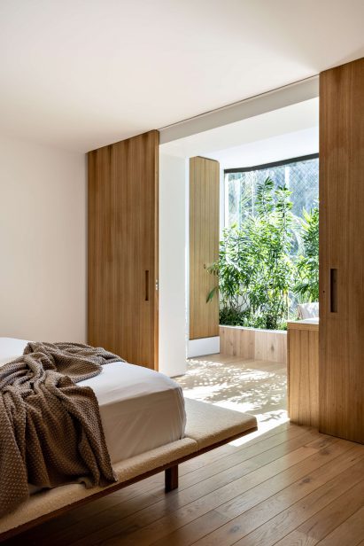 View from bedroom through sliding doors to a planted area