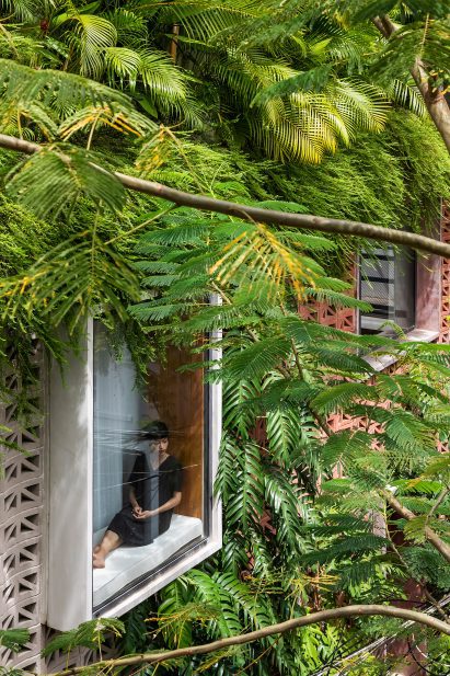 Oriel window with a seat on a perforated cement block building