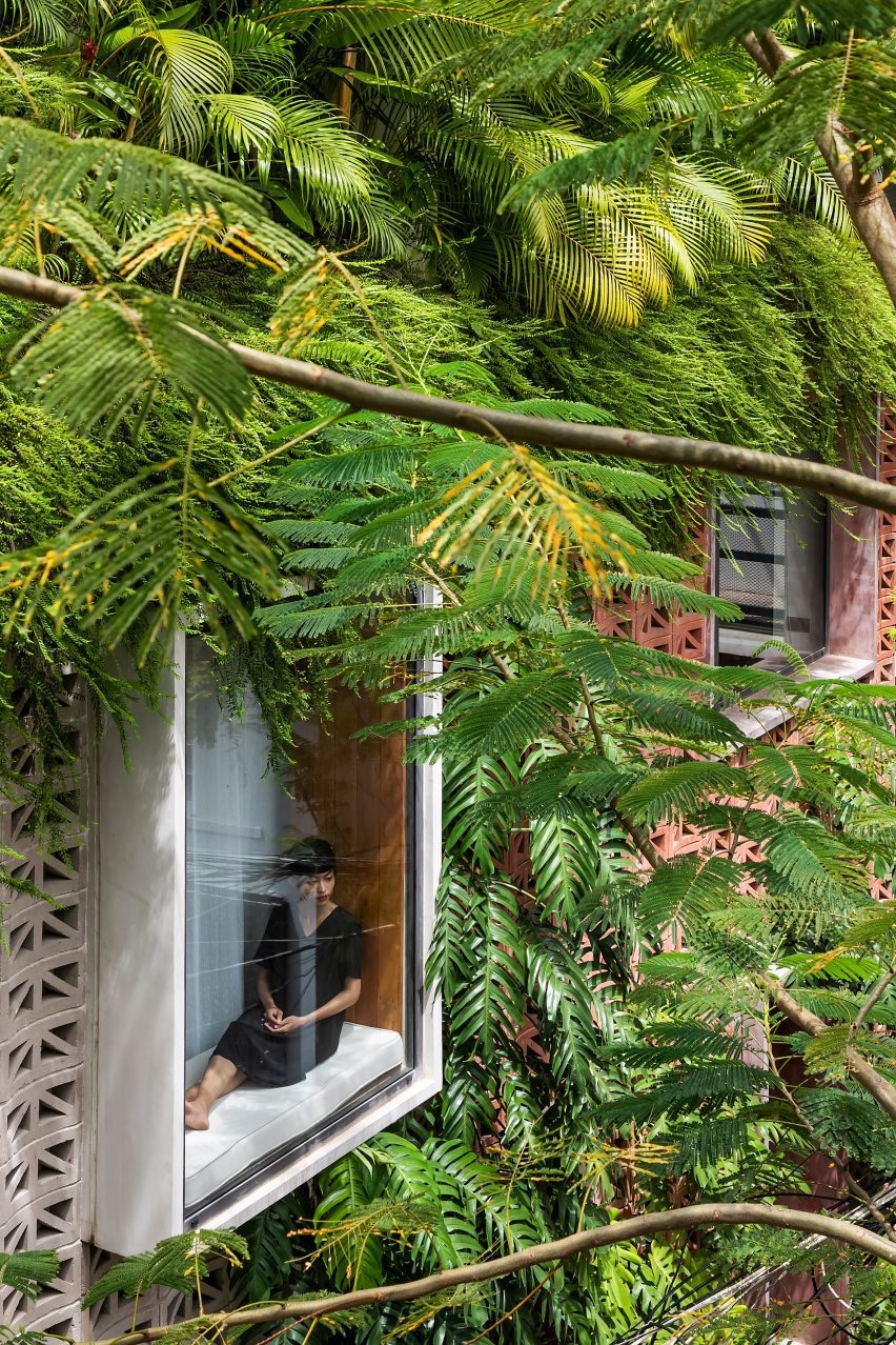 Oriel window with a seat on a perforated cement block building