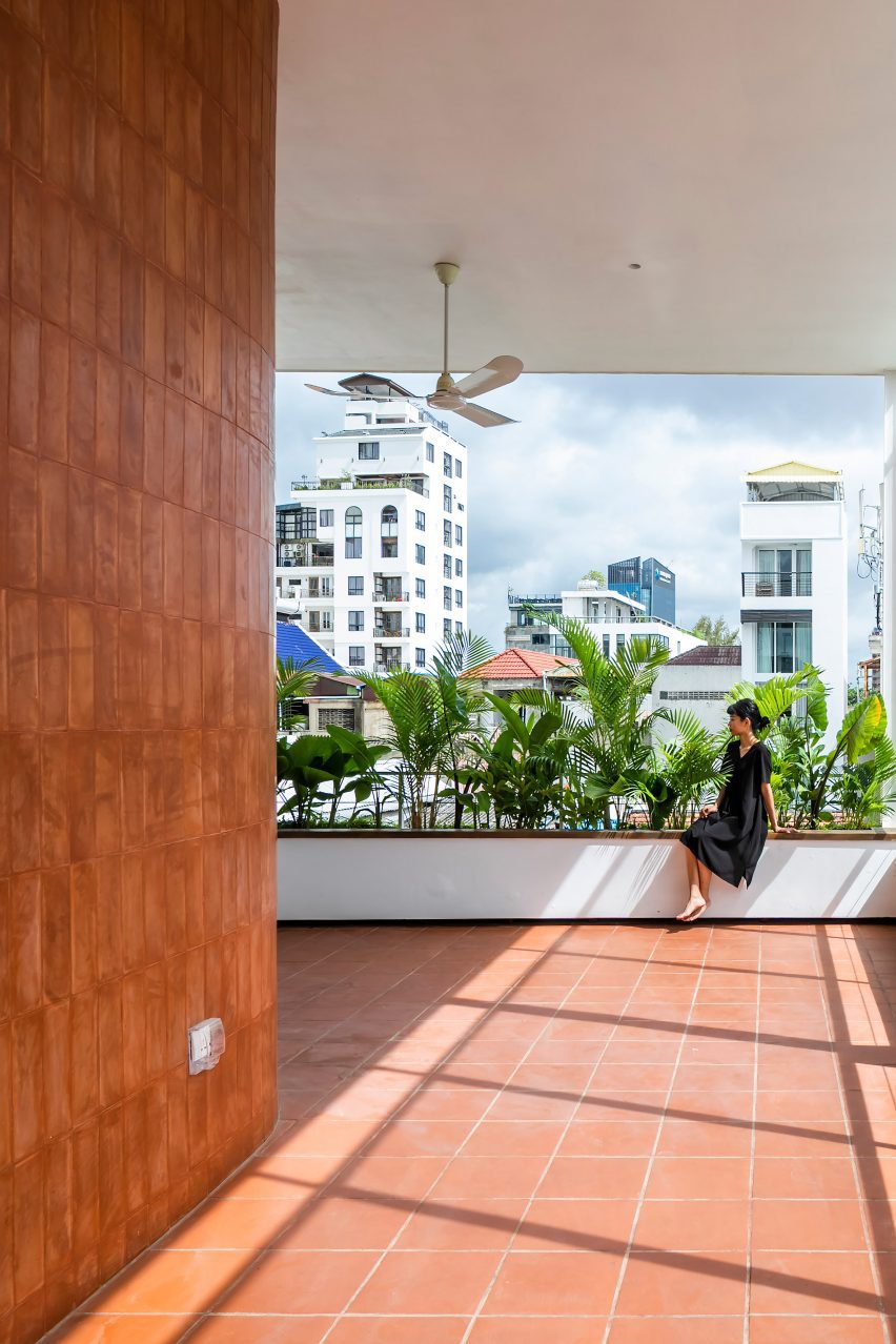 Box planting on a red-tiled terrace in Cambodia