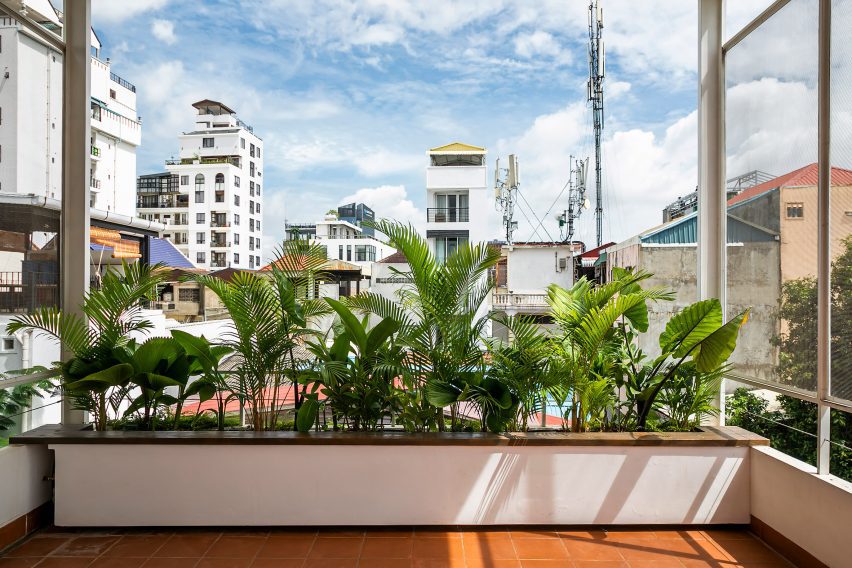 Box planting on a red-tiled terrace in Cambodia