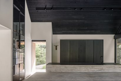 Minimalist kitchen with stone islands in a pitched roof interior