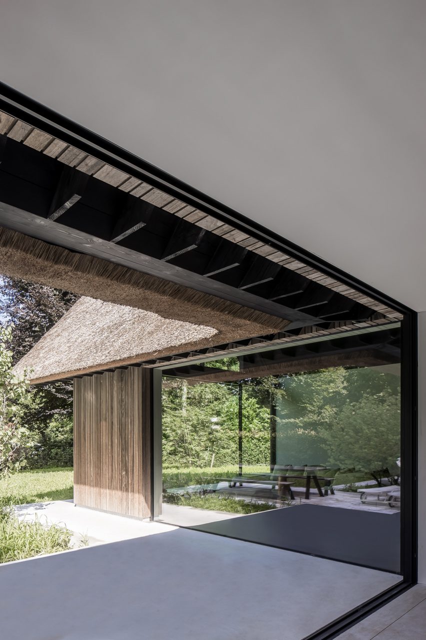 Open glass doors leading to the garden at Villa VD by Britsom Philips