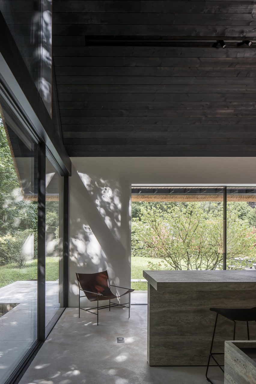 Lounge chair and stone breakfast bar in the minimalist Villa VD by Britsom Philips