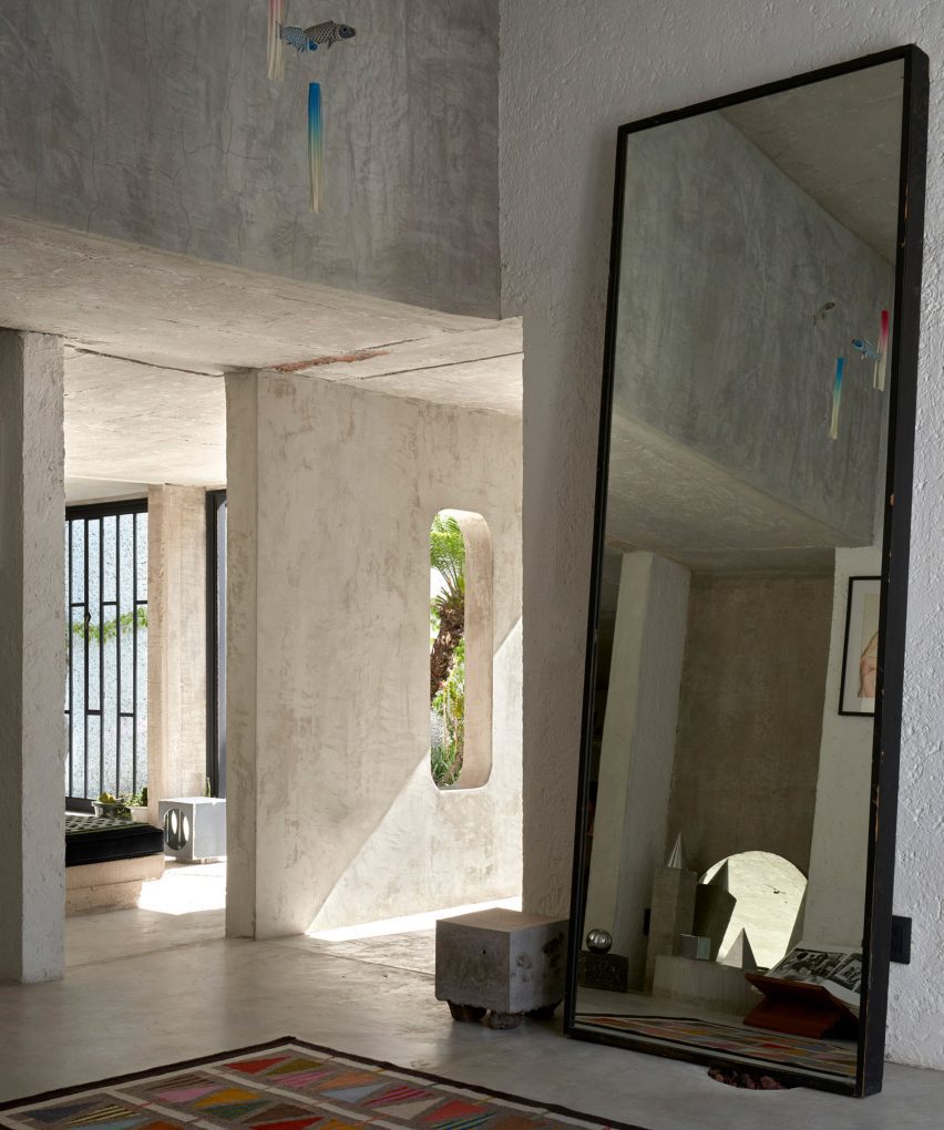 A big mirror at the entrance of a home.