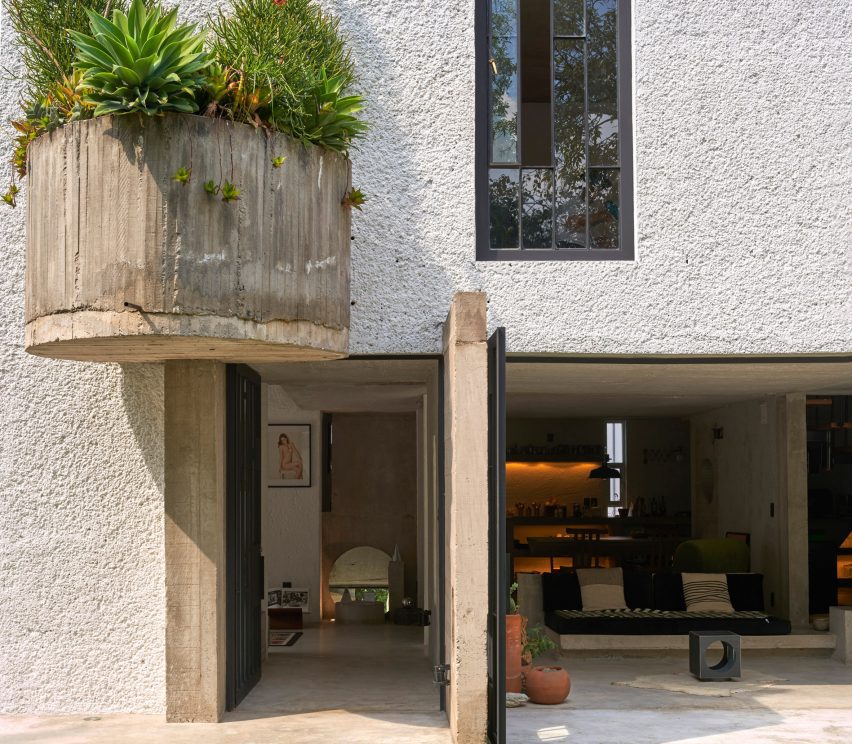 A large semi-circle planter attached to the exterior of a house