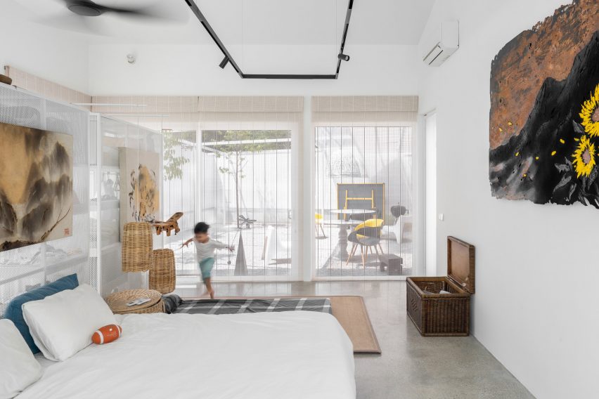 Bedroom with white walls, concrete floors and glazed sliding doors