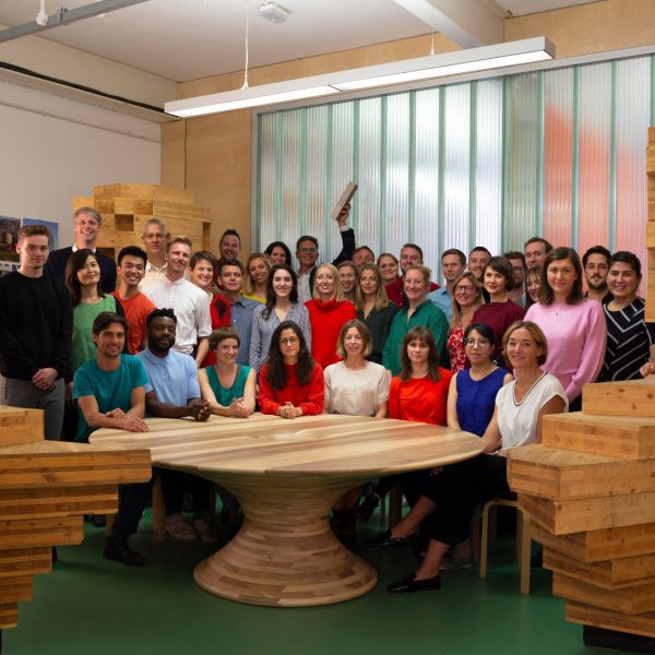 dRMM team with one individual holding up the Stirling prize trophy