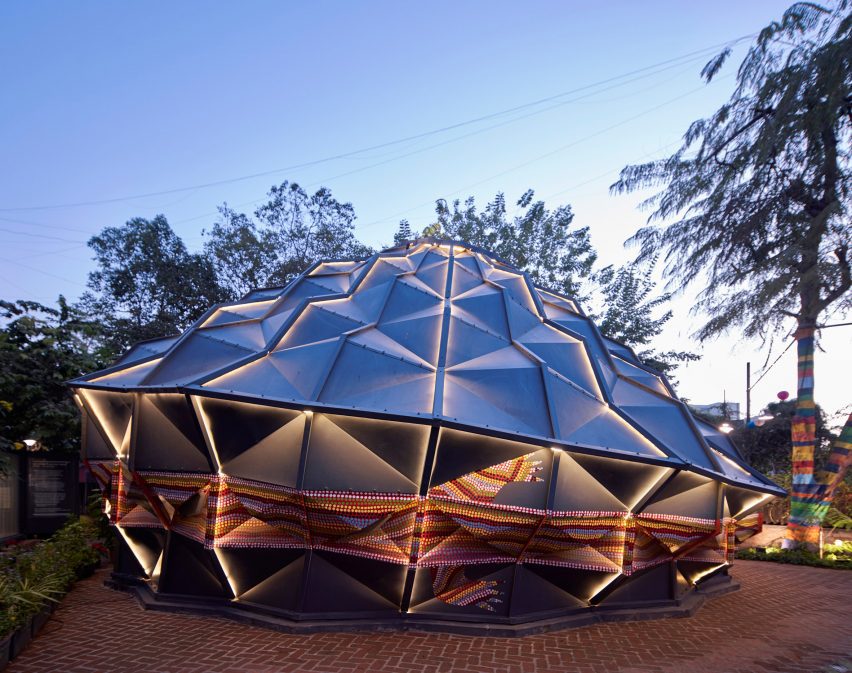 Andblack Design Studio black metal tent lit up at night