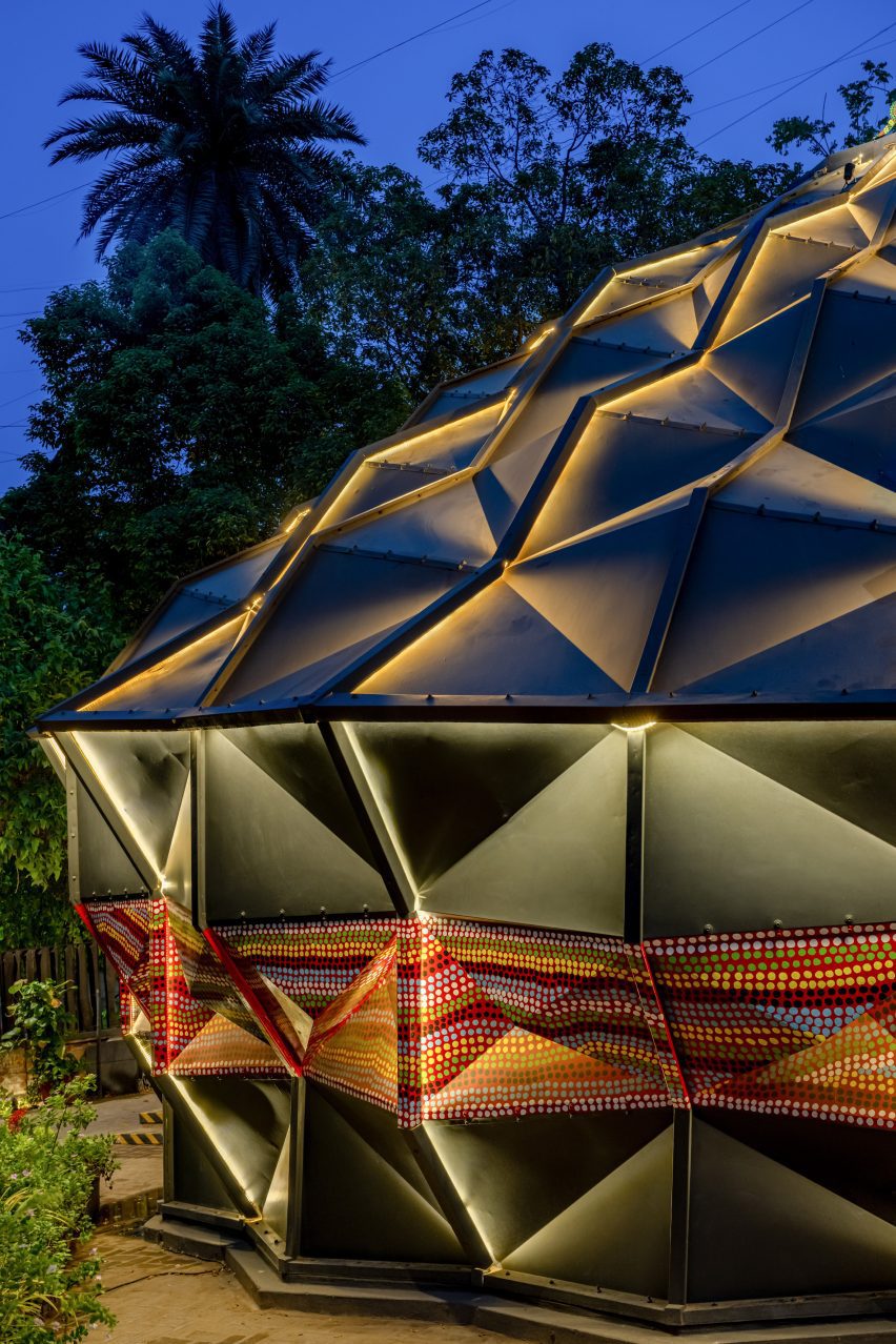 Black metal parametric tent at night