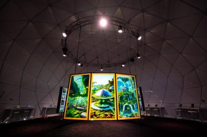 A large screen featuring AI renderings of an idealized future