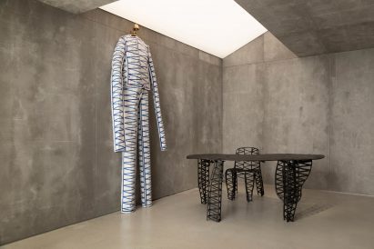 Oversized clothing and bronze furniture by Frederik Molenschot