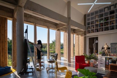 Interior of an artist's workspace with rotating bamboo screens