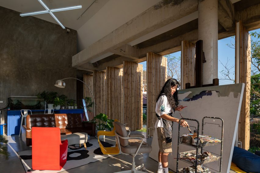 Interior of an artist's studio with rotating bamboo screens