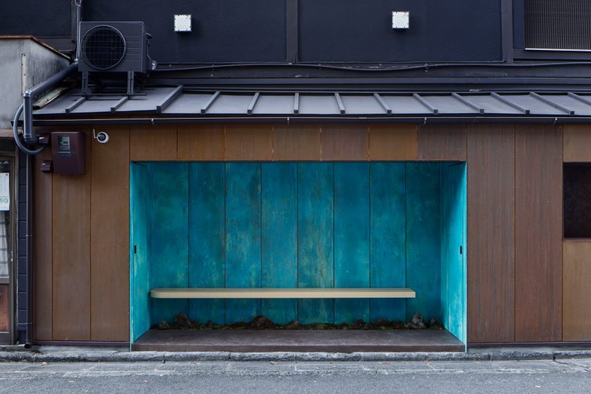 Recessed seating in a copper kiosk by G Architects Studio