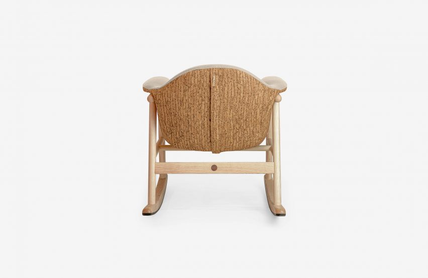 Beige-upholstered wooden rocking chair
