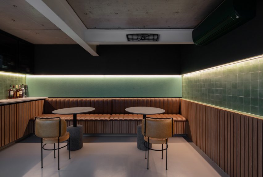 Home bar with brown leather seats and green walls
