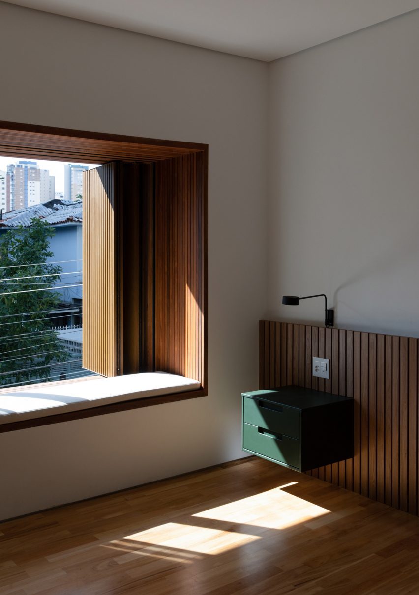 Wooden seat in a window at Casa Yuji in Sao Paulo by Goiva