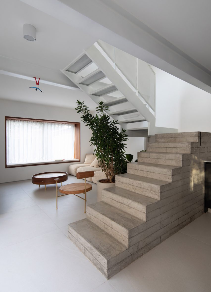 Open-plan living space with a concrete block staircase