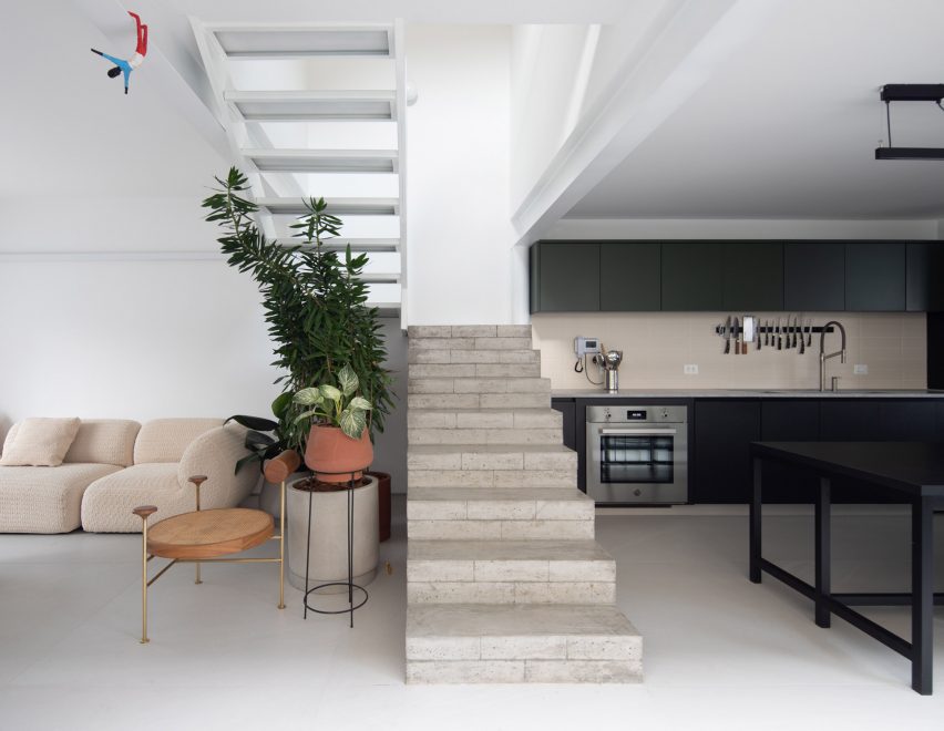 Open-plan living space with concrete staircase