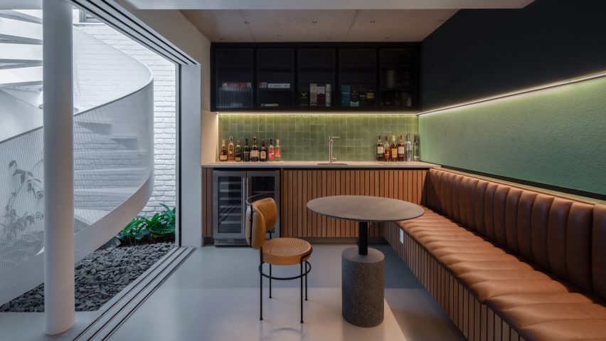 Underground bar with brown leather seating and green walls