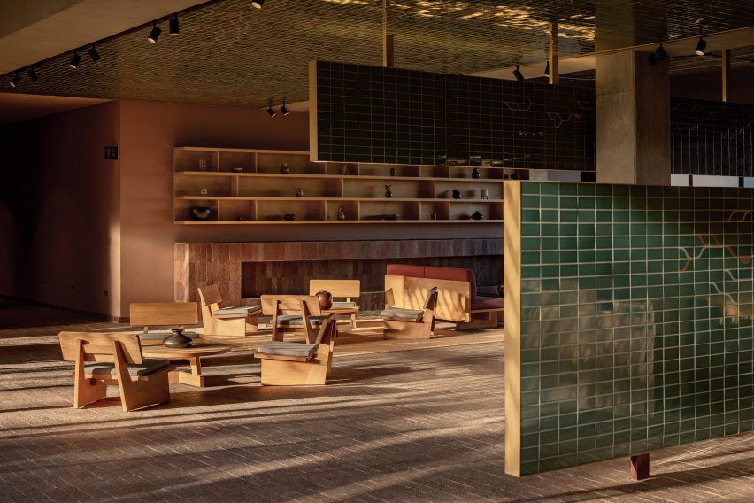 Hotel lobby in the evening sun with a wall of red-clay wall
