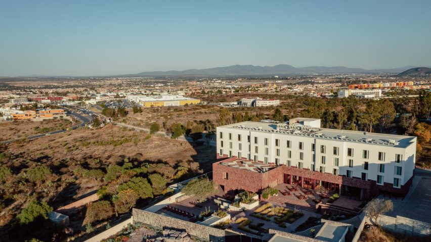 A hotel perched on a hill overlooking a town in Mexico