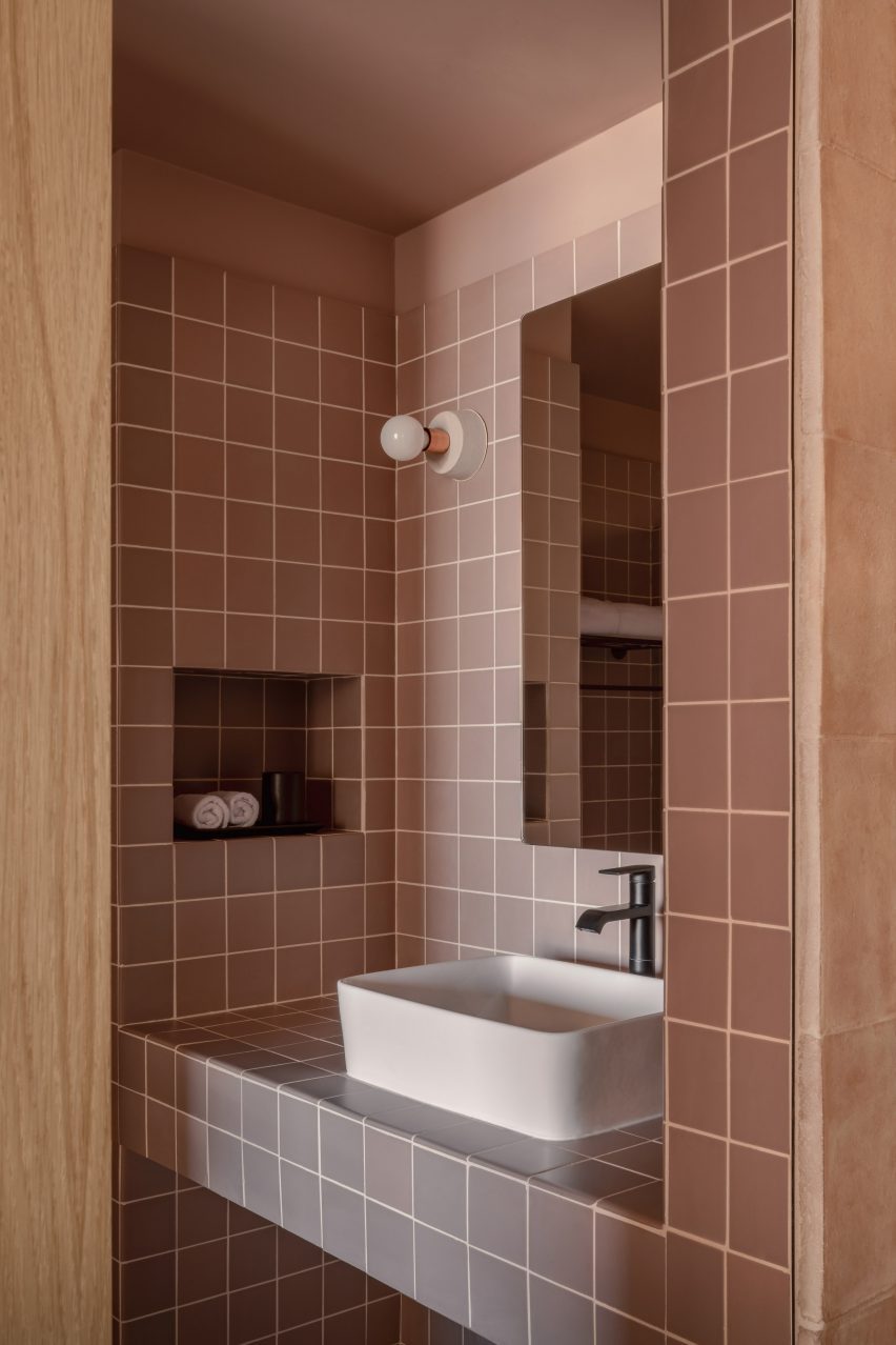A bathroom made with soft pinkish tiles