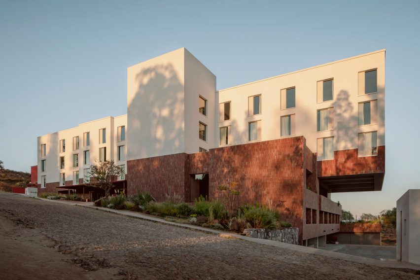 A T-shaped hotel located on a hill