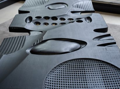 Close-up of ridges and patterns carved into wooden bench