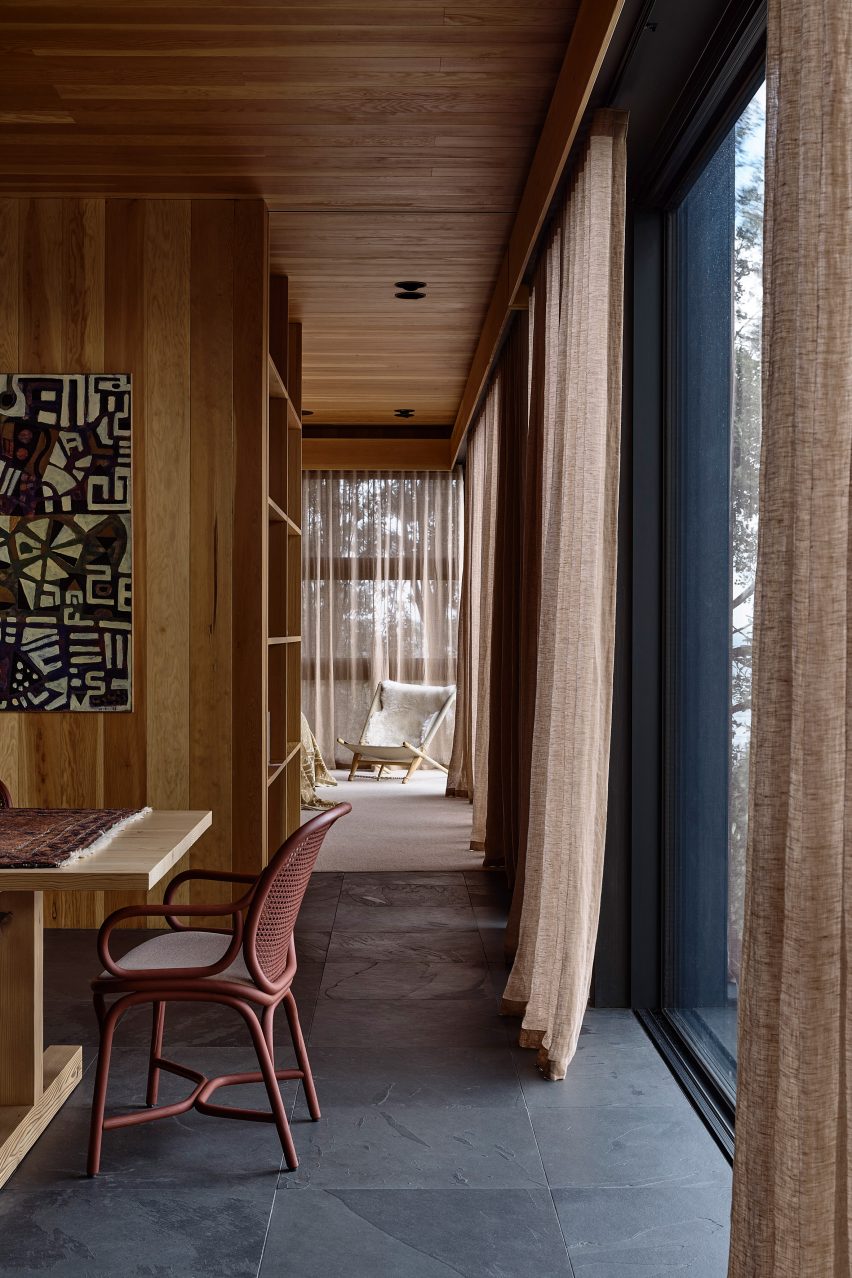Study with grey flooring and wood-lined walls and ceiling
