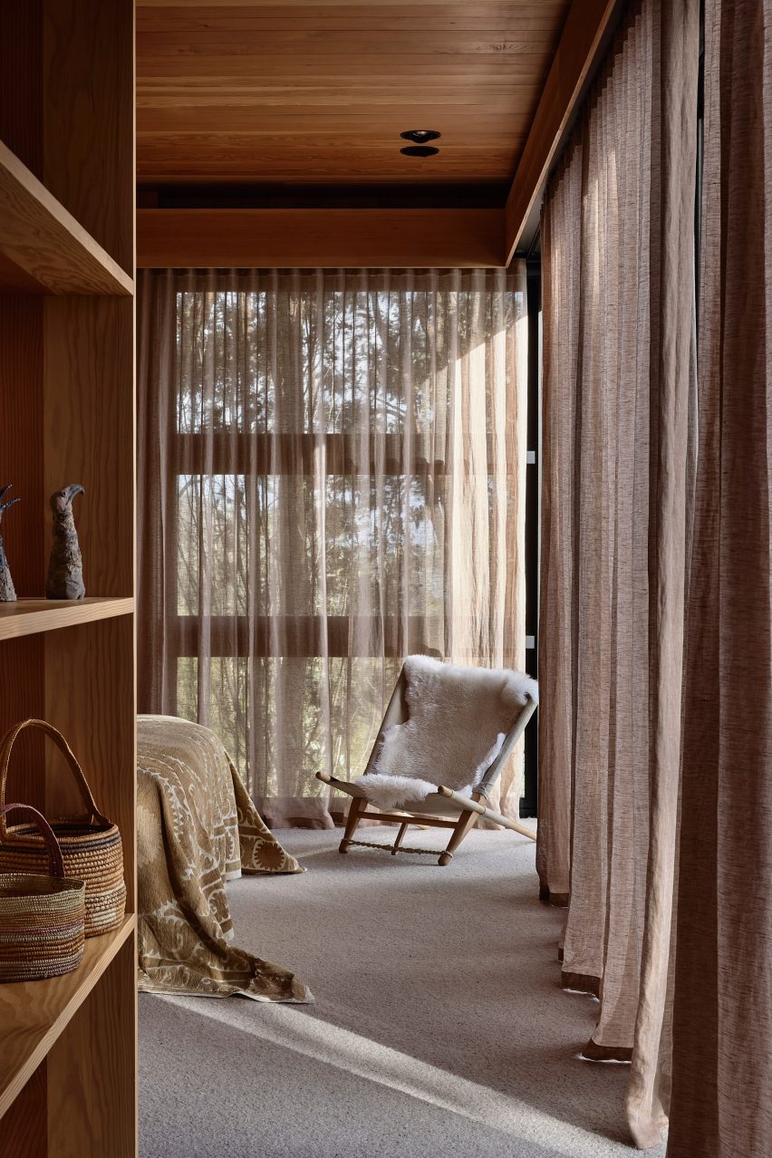 Bedroom with glazed walls and wood shelving