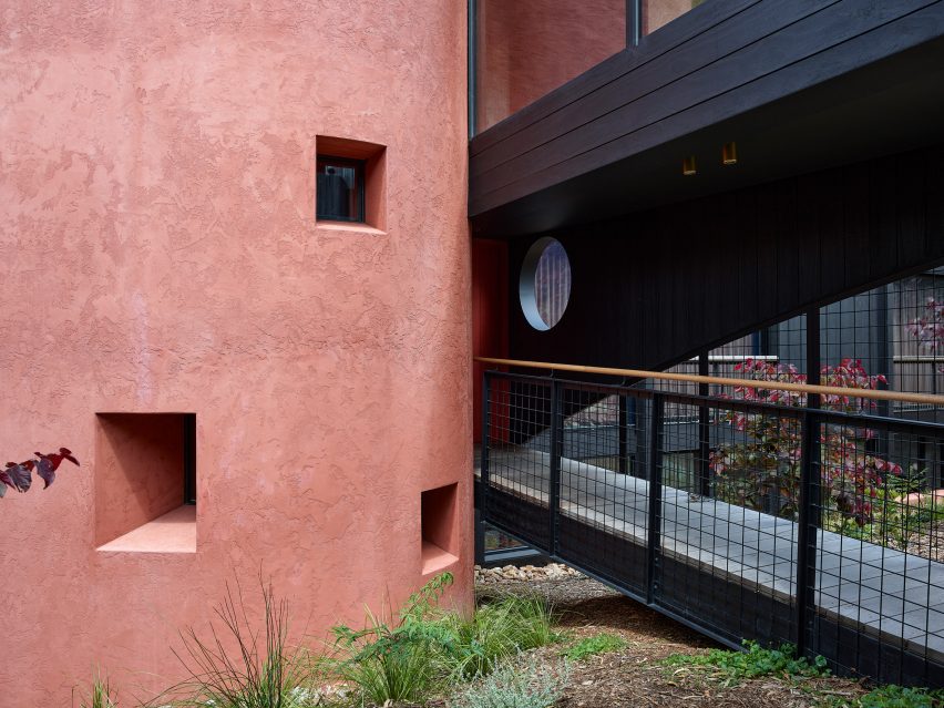 Red render and black timber house