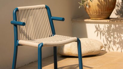 Photograph of blue and beige chair by pool
