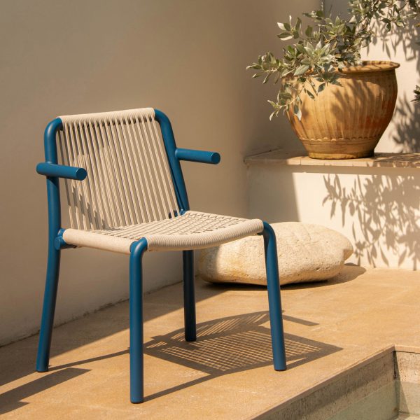 Photograph of blue and beige chair by pool