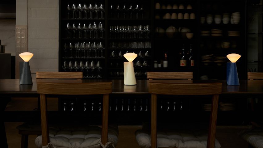 Lamps on table in dimly-lit restaurant