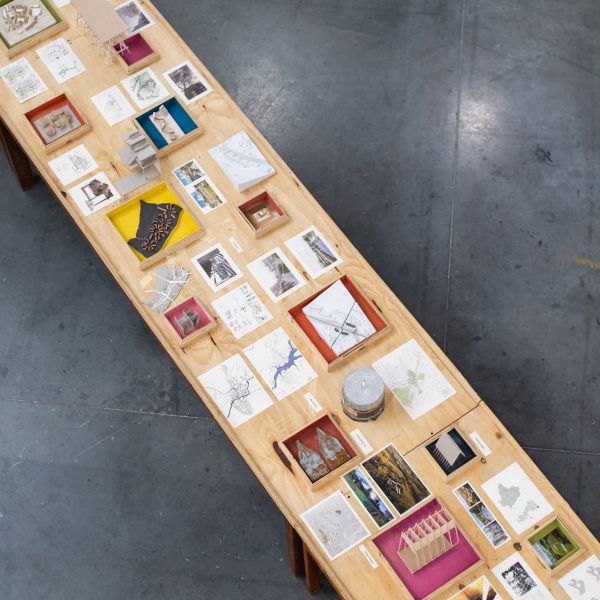 a photograph from above of a table with multiple student projects on it