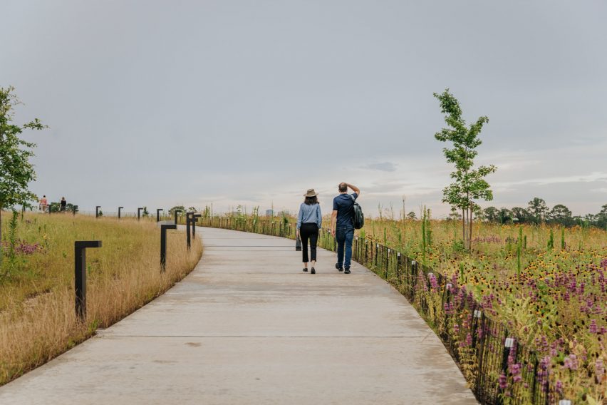 Two people walking up a hill