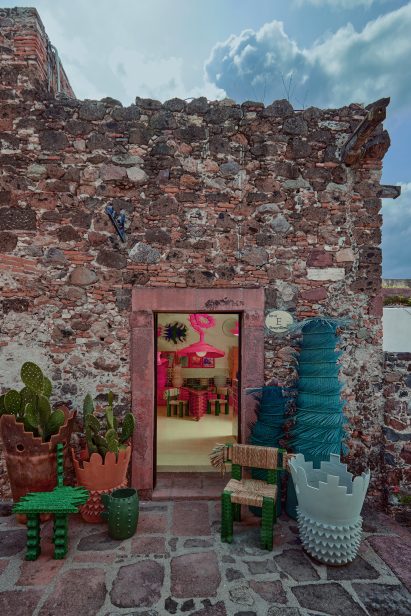 Stone building exterior with view into showroom