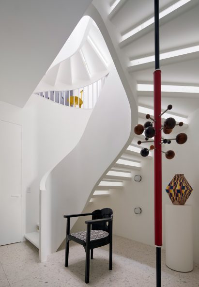 Curved staircase topped with a skylight