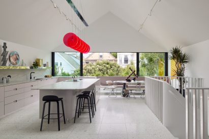 Penthouse-style white kitchen with gabled roof