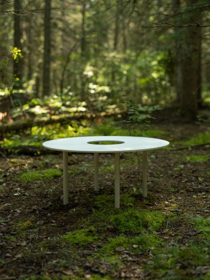 A small circular, flat metal benches