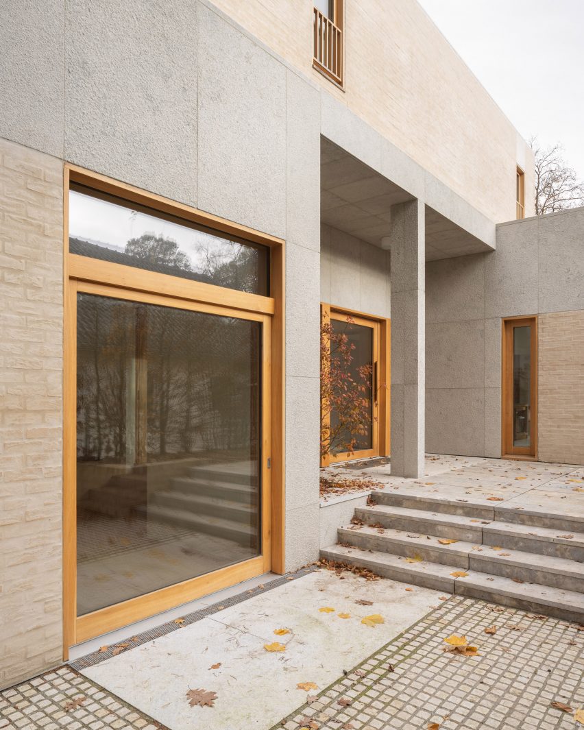 Patio outside a brick and limestone home