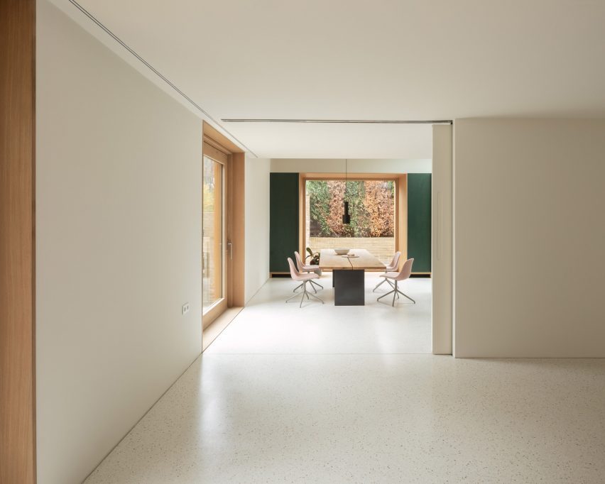 White residential interior with windows looking out to a wooded area
