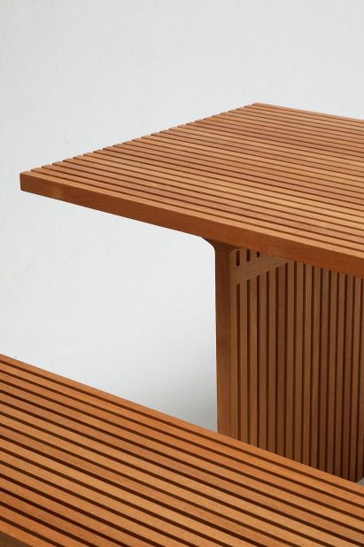 Photograph of wooden bench and table on white backdrop