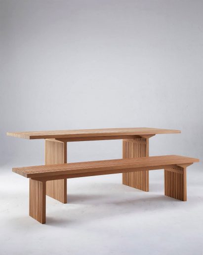 Wooden table and bench in white room