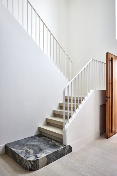 The entrance to a home with a stone slab for a landing