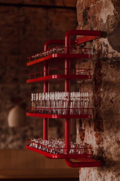 Red glass shelves inside The Taproom bar at Tenczynek Brewery